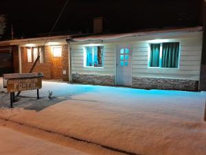 a sign in front of a house at night at DEPARTAMENTOS FORTIN in Trevelín