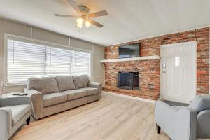 a living room with a couch and a fireplace at Sun-Soaked Okeechobee Retreat with Canal Views! in Okeechobee