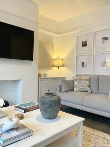 a living room with a couch and a table at Windsor Cottage in Amble