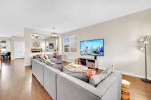 a living room with couches and a flat screen tv at Seven Palms in Henderson