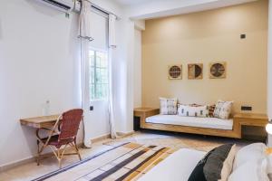 a bedroom with a bed and a desk at Heirloom Guesthouse in Dimāpur +53 photos