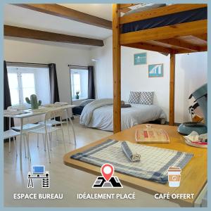 a bedroom with a bed and a table with a table at ღ Marché Central • Au cœur de ville & Spacieux in La Rochelle