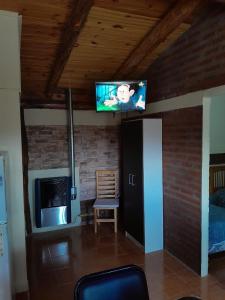 a living room with a flat screen tv on the ceiling at DEPARTAMENTOS FORTIN in Trevelin
