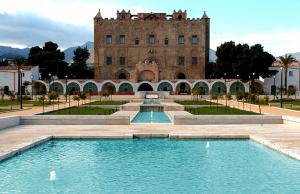 a building with a swimming pool in front of a building at La Casa di Edo in Palermo