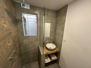 a bathroom with a sink and a shower at Hotel Bermudas in Mar del Plata +31 photos