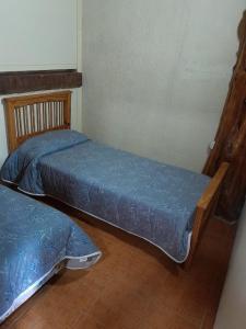 two twin beds in a room with at DEPARTAMENTOS FORTIN in Trevelin