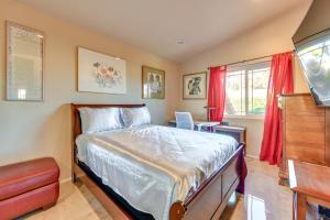 a bedroom with a bed and a flat screen tv at Cathedral City Gem with Shared Pool and Fireplace in Cathedral City