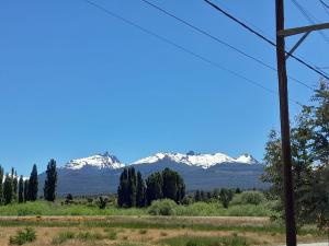 a view of snow capped mountains from a road at DEPARTAMENTOS FORTIN in Trevelín +5 photos