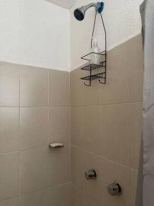a bathroom with a shower with a light on the ceiling at Depa Meraki More in Morelia