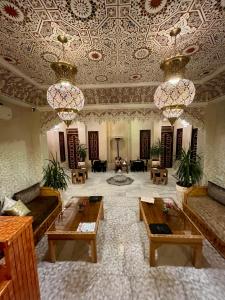 a large lobby with tables and chandeliers at Riad Alice Terrace & Spa in Marrakech