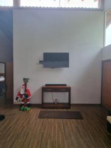 a living room with a flat screen tv on a wall at La Marujita villa de campo in Puerto Quito