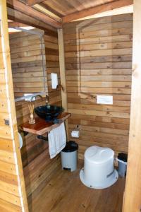 a bathroom with a toilet and a sink at Ecohousing Del Bosque in San Rafael