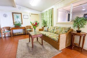a living room with a couch and a table at Kauai Palms Hotel in Lihue