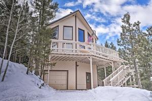 a house with a wrap around deck in the snow at Spacious Mountain-View Cabin By Angel Fire Resort in Angel Fire