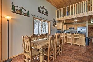 a dining room and kitchen with a table and chairs at Spacious Mountain-View Cabin By Angel Fire Resort in Angel Fire