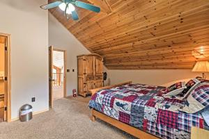 a bedroom with a bed and a wooden ceiling at Spacious Mountain-View Cabin By Angel Fire Resort in Angel Fire