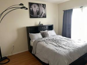 a bedroom with a bed and a lamp and a window at Luxury 2 bedroom apartment in downtown LA! in Los Angeles