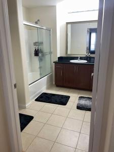 a bathroom with a glass shower and a sink at Luxury 2 bedroom apartment in downtown LA! in Los Angeles