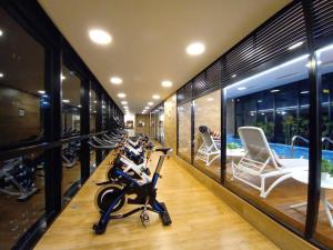 a gym with a row of exercise bikes and a swimming pool at Bespoke Suite, Unique Location, Complementary Airport Pick Up in Bogotá