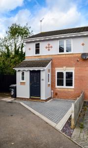 a detached house with a driveway in front of it at Ripon House in Dallington