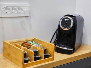 a toaster sitting on a counter next to a box of cupcakes at Akis CityChic Apartment in Cluj-Napoca