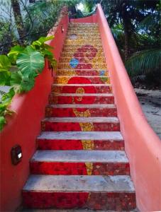 a staircase with a painting of a woman on it at Mayan Beach Garden in El Placer