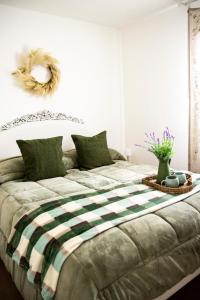 a bedroom with a large bed with a wreath on the wall at Palazzo Donnamaria in Manfredonia