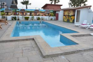 a swimming pool in the middle of a patio at Ocean Villa Heights in Brufut