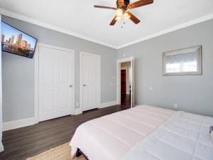 a bedroom with a white bed and a ceiling fan at Modern Westshore in Tampa