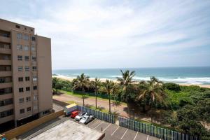 a view of the beach from the balcony of a building at Amanzi402 Oceanview Retreat in Amanzimtoti
