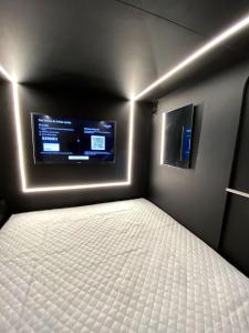 a bedroom with a bed and a flat screen tv at Hotel Joy Cll 85 in Bogotá