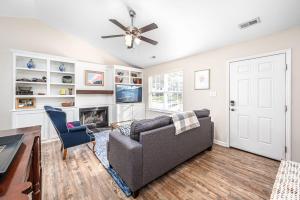 a living room with a couch and a fireplace at Cozy Pet friendly home-Raleigh in Raleigh