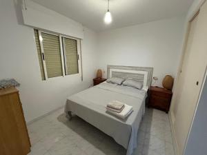 a bedroom with a bed with two towels on it at Apartement à La Mata in Torrevieja