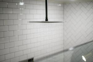 aendant light hanging from a white tiled wall at Cozy Cabin Perfect for Couples in Broken Bow +40 photos