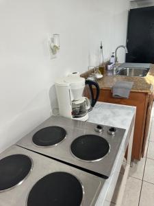 a kitchen with a stove top with a mixer on it at Cozy Spacious Guest Suite in Englewood