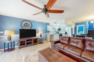 a living room with a couch and a flat screen tv at Ocean Mile B2 in St. George Island