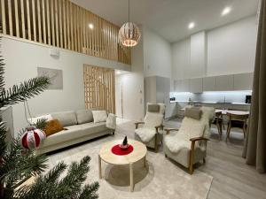 a living room with a couch and a table at Nordic Wooden House in Rovaniemi