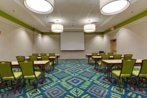 a conference room with tables and chairs and a whiteboard at Drury Plaza Hotel Columbia East in Columbia