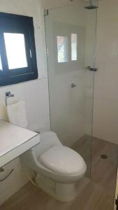 a bathroom with a toilet and a glass shower at Cabaña Recinto del Pensar in Santa Marta +137 photos