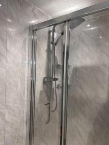 a shower with a glass door in a bathroom at Stunning 2 Bedroom duplex in the Heart of London in London