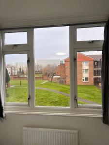 a window in a room with a view of a field at Stunning 2 Bedroom duplex in the Heart of London in London