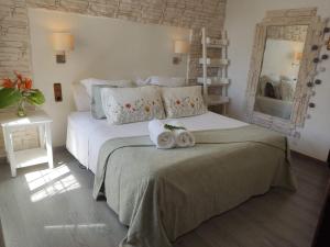 a bedroom with a bed with two towels on it at Villa Santos in Elche +20 photos