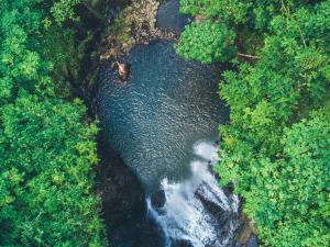 an aerial view of a waterfall in a river at Koro Sun Resort & Rainforest Spa in Savusavu