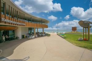 a building on the beach with the ocean in the background at Seaside Bliss in Perth