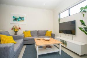 a living room with a couch and a table at Seaside Bliss in Perth