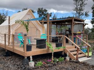 a house with a tent and chairs in it at Tiki Cabana in Hawaiian Ocean View