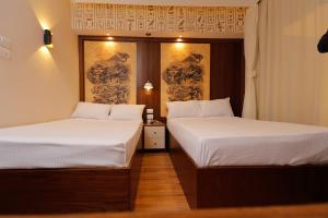 Voodi või voodid majutusasutuse Sky Pyramids View Inn toas