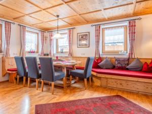 a living room with a red couch and a table at Rosalie-Lorena in Ramsau im Zillertal