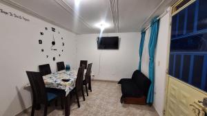 a dining room with a table and a clock on the wall at Habita Living Bogotá in Bogotá