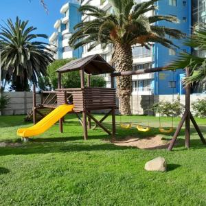a playground in a park with a slide at Departamento JARDIN DEL MAR, 2 Dormitorios in Coquimbo